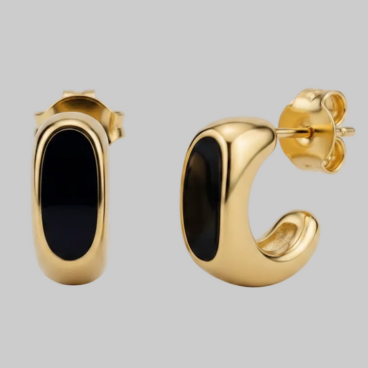 A pair of gold-toned curved hoop-style earrings with dark navy inlay, shown from front and side angles on a clean light gray background.